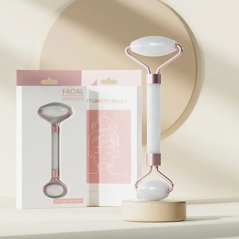 Face and neck massager roller displayed with elegant packaging on a minimalist background.