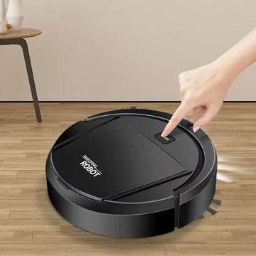 Automatic robot vacuum cleaner with a sleek design, being turned on for effortless cleaning on wooden floors.