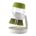 Multifunctional cleaning brush with soap dispenser for kitchen use, featuring a green and white design for easy washing.
