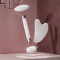 White face and neck massager roller with pink accents, perfect for lifting and toning skin.