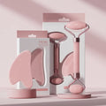 Face and neck massager roller set in pink packaging for skincare enhancement and relaxation.